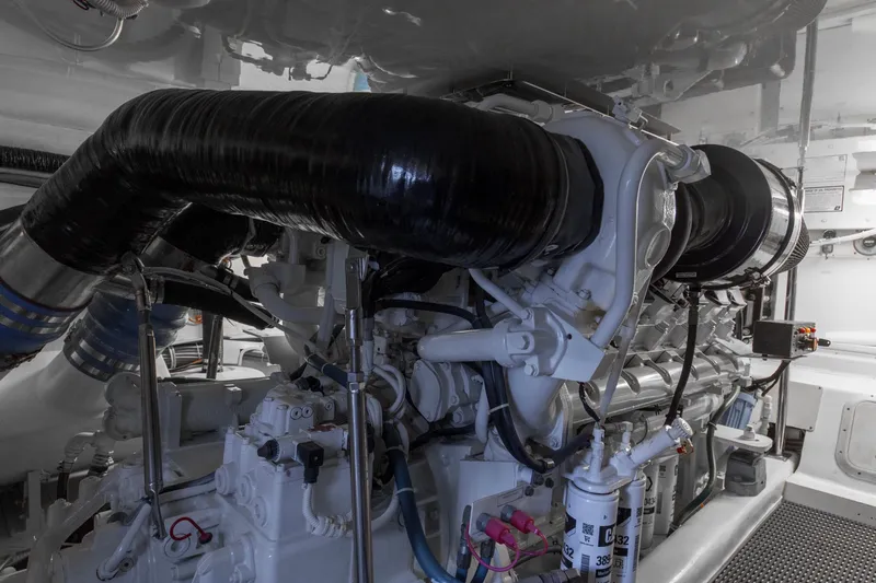 Lady A Yacht Photos Pics Engine room of 2008 Hatteras 54 Convertible yacht, showcasing complex machinery and components.