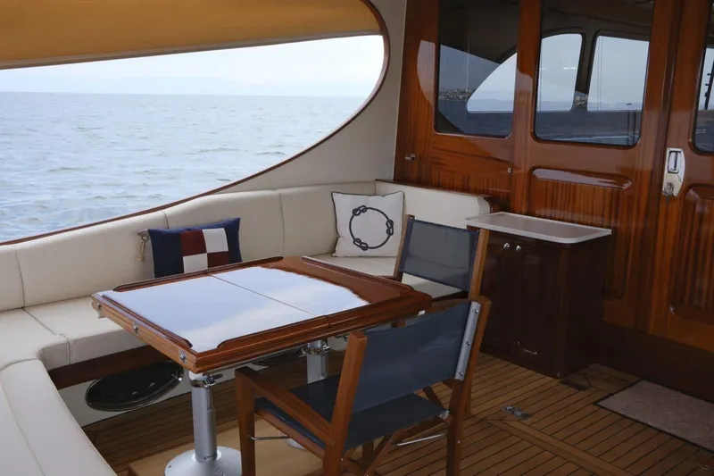  Yacht Photos Pics Luxurious 2009 Vicem Classic 71 yacht interior with elegant seating and wooden table.