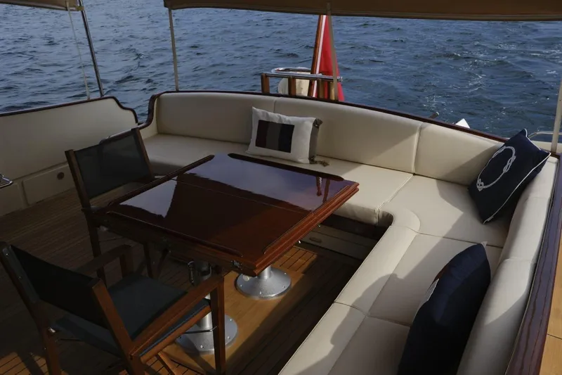  Yacht Photos Pics Luxurious seating area on 2009 Vicem Classic 71 yacht with elegant wooden table.