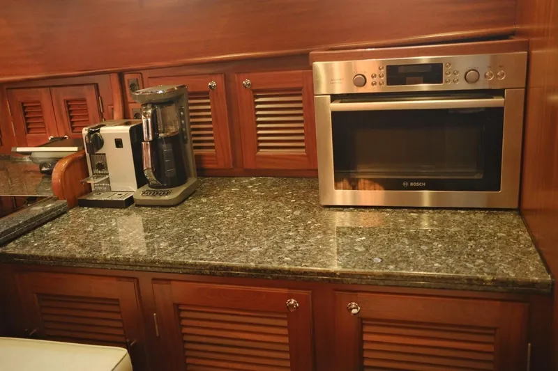  Yacht Photos Pics Luxurious kitchen area in 2009 Vicem Classic 71 yacht with granite countertop and modern appliances.