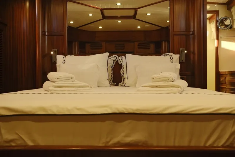  Yacht Photos Pics Luxurious bedroom interior of 2009 Vicem Classic 71 yacht with elegant wood paneling.