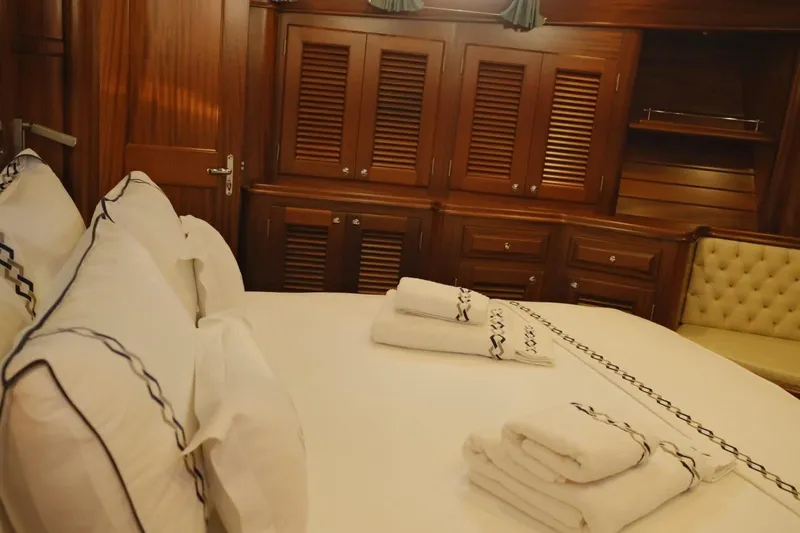  Yacht Photos Pics Luxurious cabin interior of 2009 Vicem Classic 71 yacht with elegant wood paneling and plush bedding.