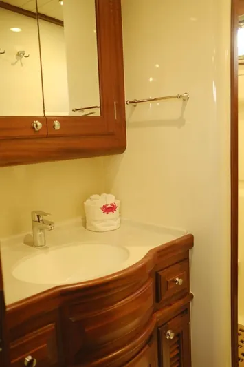  Yacht Photos Pics Luxurious bathroom in 2009 Vicem Classic 71 yacht with wooden cabinetry and modern fixtures.