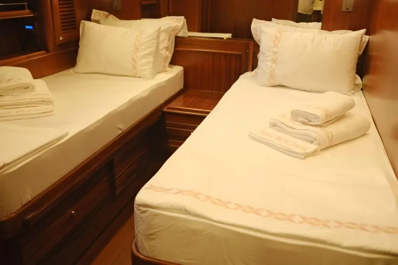  Yacht Photos Pics Twin beds in the 2009 Vicem Classic 71 yacht cabin, featuring elegant wood paneling.