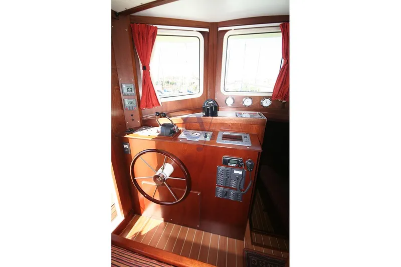  Yacht Photos Pics Pilot cabin of Sibma Navale Italiana Armstrong 12, 2012 model, featuring wooden interior and navigation equipment.