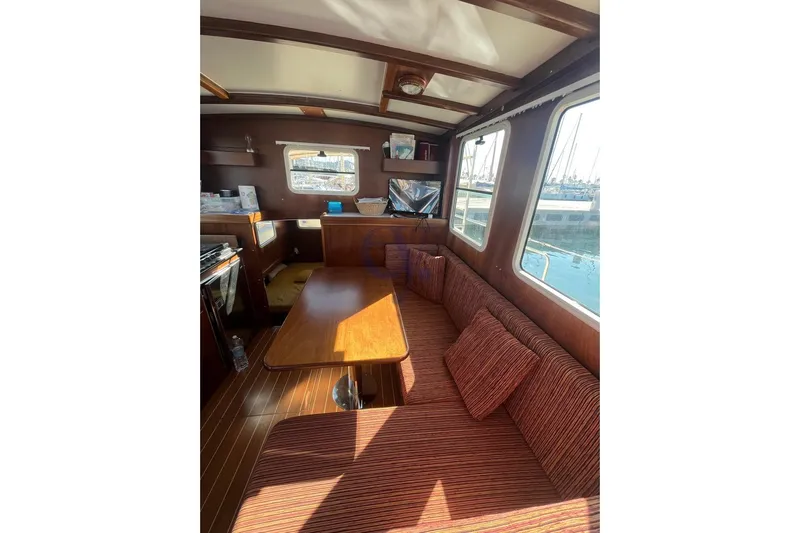  Yacht Photos Pics Cozy interior of 2012 Sibma Navale Italiana Armstrong 12 boat with wooden table and seating.