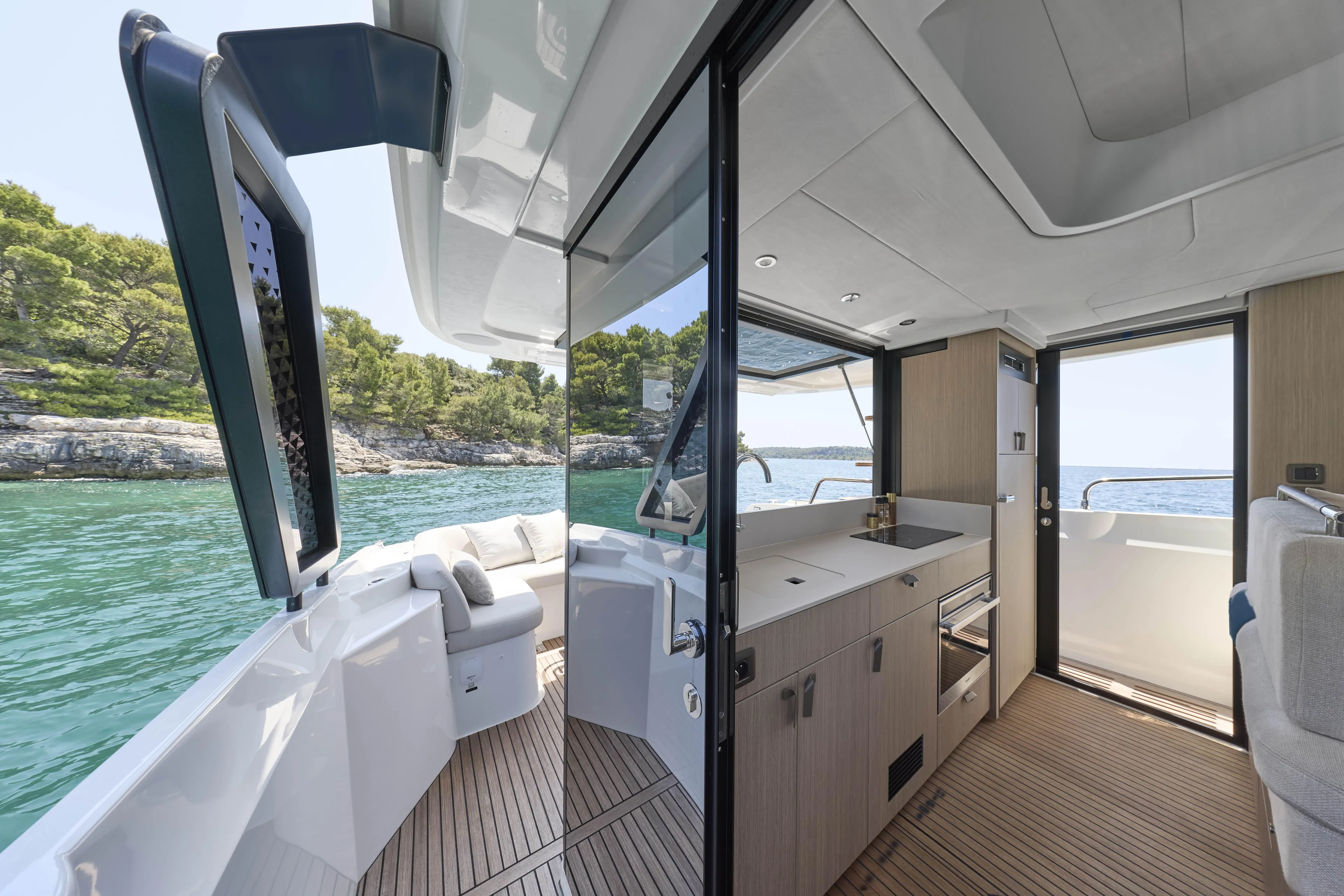  Yacht Photos Pics Luxurious 2026 Prestige F4.3 yacht interior with modern kitchen and scenic ocean view.