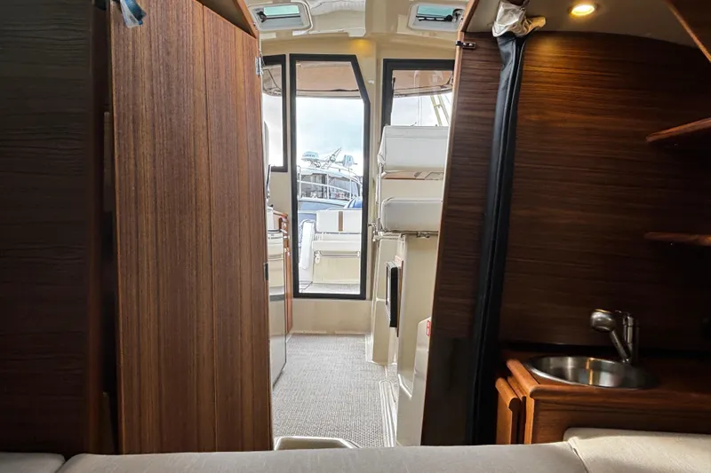  Yacht Photos Pics Interior view of 2026 Ranger Tugs R-23 boat, featuring wood paneling and compact design.