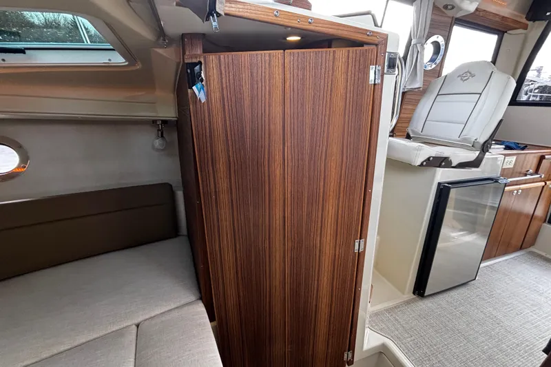  Yacht Photos Pics Interior of 2026 Ranger Tugs R-23 boat, featuring wood paneling and seating area.