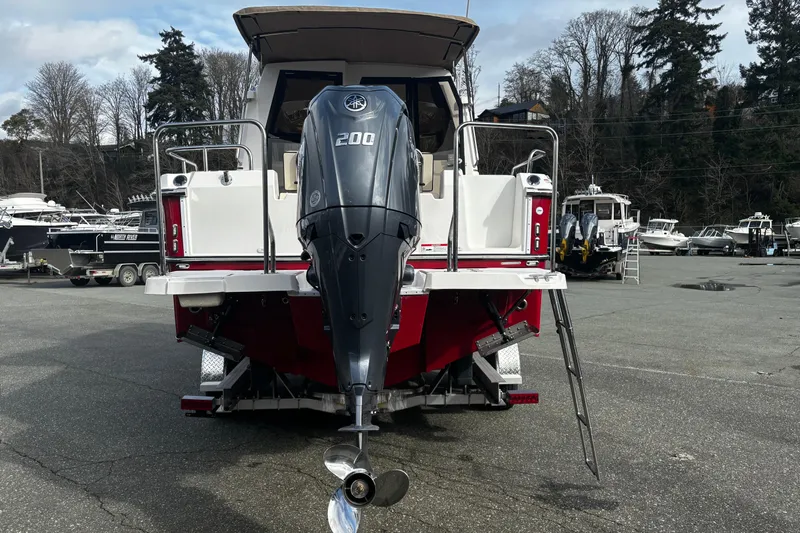  Yacht Photos Pics 2026 Ranger Tugs R-23 boat with powerful outboard motor, parked in a marina.