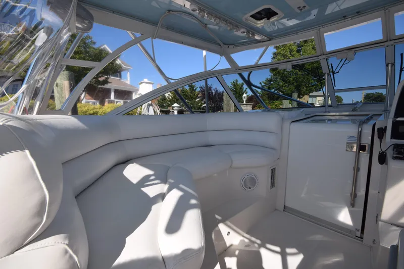  Yacht Photos Pics Interior of 2009 Jupiter 39 Express boat with white seating and panoramic windows.