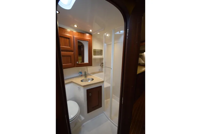  Yacht Photos Pics 2009 Jupiter 39 Express yacht bathroom with wooden cabinets and modern fixtures.