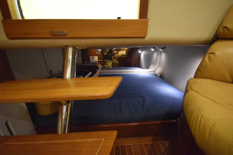  Yacht Photos Pics Interior cabin of 2009 Jupiter 39 Express with wooden steps and cozy sleeping area.