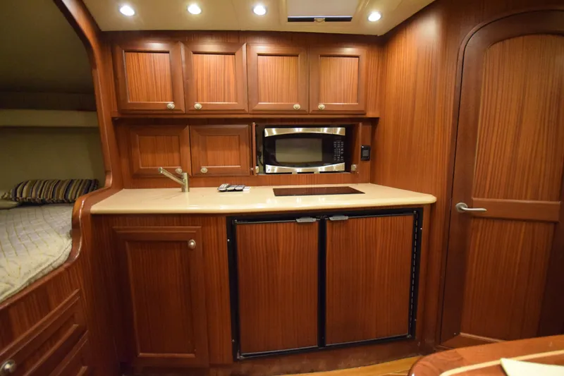  Yacht Photos Pics Luxurious 2009 Jupiter 39 Express yacht interior with wood cabinetry and modern kitchen amenities.