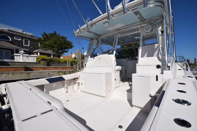  Yacht Photos Pics 2009 Jupiter 39 Express boat with spacious deck and seating, docked near waterfront homes.