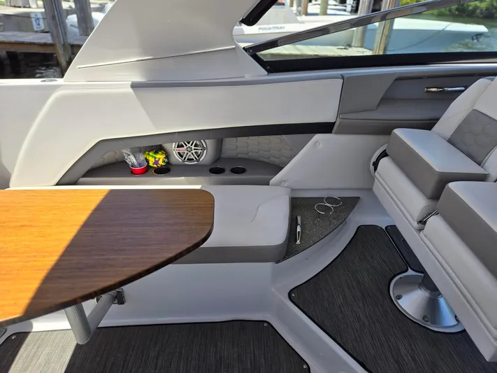 Love You More Yacht Photos Pics Interior of 2019 Four Winns H350 boat with seating and wooden table.