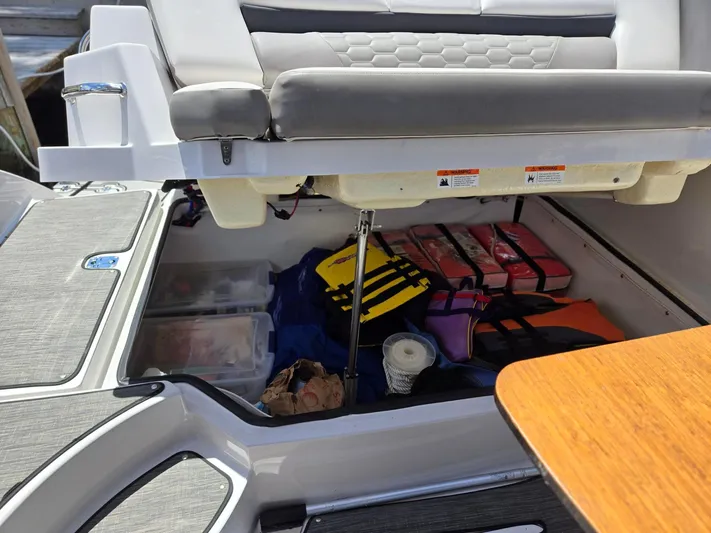 Love You More Yacht Photos Pics Storage compartment of 2019 Four Winns H350 boat with life jackets and supplies.