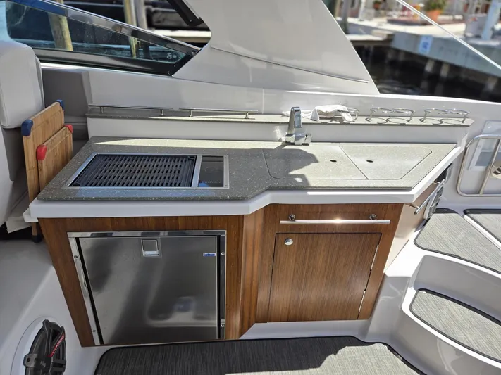 Love You More Yacht Photos Pics 2019 Four Winns H350 boat kitchenette with sink, grill, and storage cabinets.