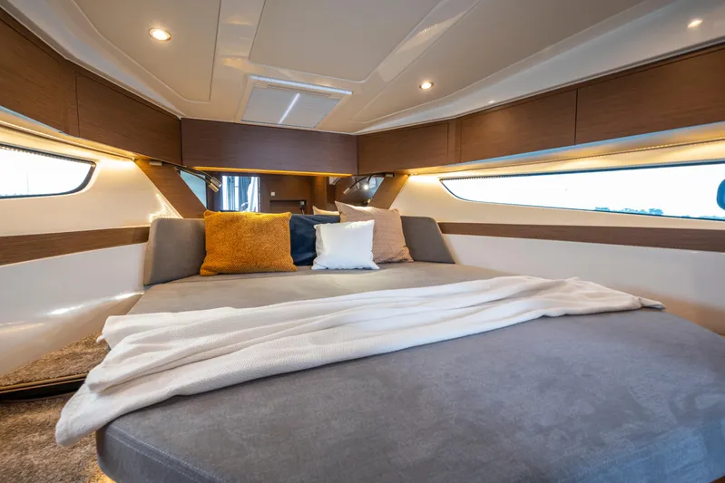 Yacht Photos Pics Luxurious interior of 2026 Beneteau Antares 11 Coupe with cozy bedding and modern design.