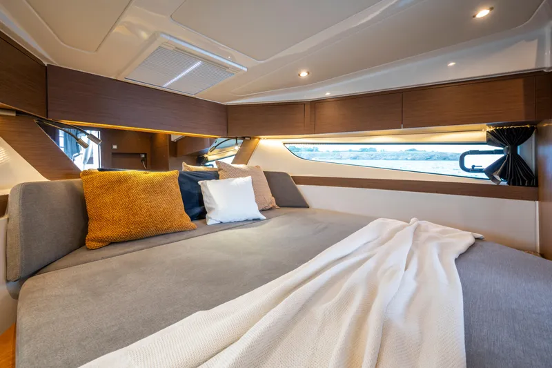  Yacht Photos Pics Luxurious cabin interior of 2026 Beneteau Antares 11 Coupe with cozy bedding.