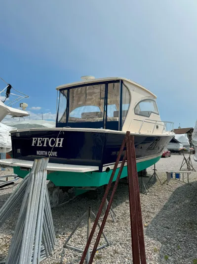 Fetch Yacht Photos Pics 2004 Mainship Pilot 34 boat on dry dock, named "FETCH," with a blue hull and white cabin.