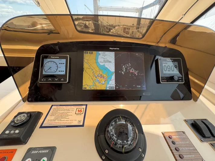 Fetch Yacht Photos Pics 2004 Mainship Pilot 34 dashboard with navigation instruments and compass.