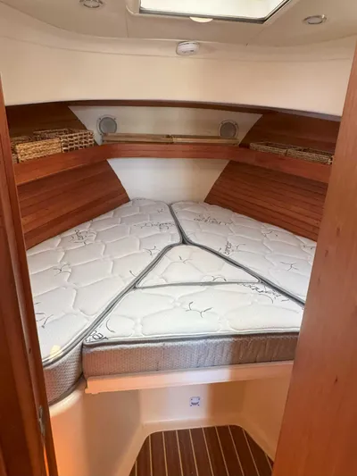 Fetch Yacht Photos Pics 2004 Mainship Pilot 34 cabin with V-berth and wooden accents.