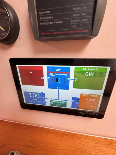 Fetch Yacht Photos Pics Control panel display on a 2004 Mainship Pilot 34 boat, showing energy usage and power status.