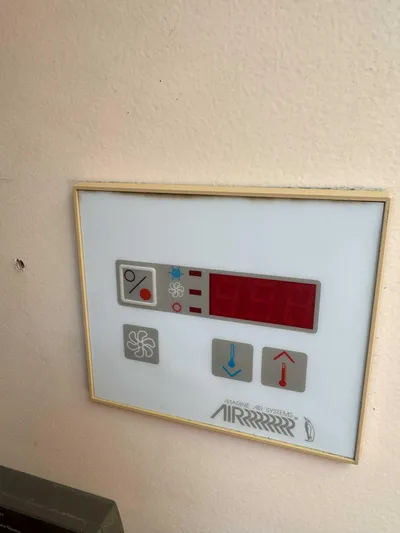 Fetch Yacht Photos Pics Control panel on a 2004 Mainship Pilot 34 boat, featuring temperature and fan settings.