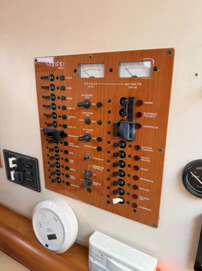 Fetch Yacht Photos Pics Electrical control panel on a 2004 Mainship Pilot 34 boat interior.