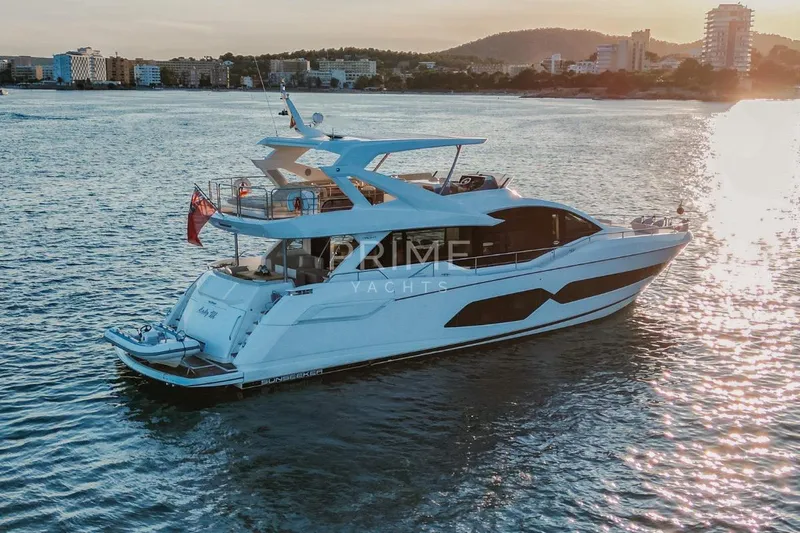 Lady M Yacht Photos Pics 2019 Sunseeker 76 Yacht cruising on serene waters at sunset.