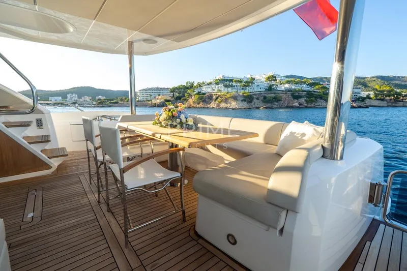 Lady M Yacht Photos Pics Luxurious 2019 Sunseeker 76 Yacht deck with elegant seating and scenic ocean view.