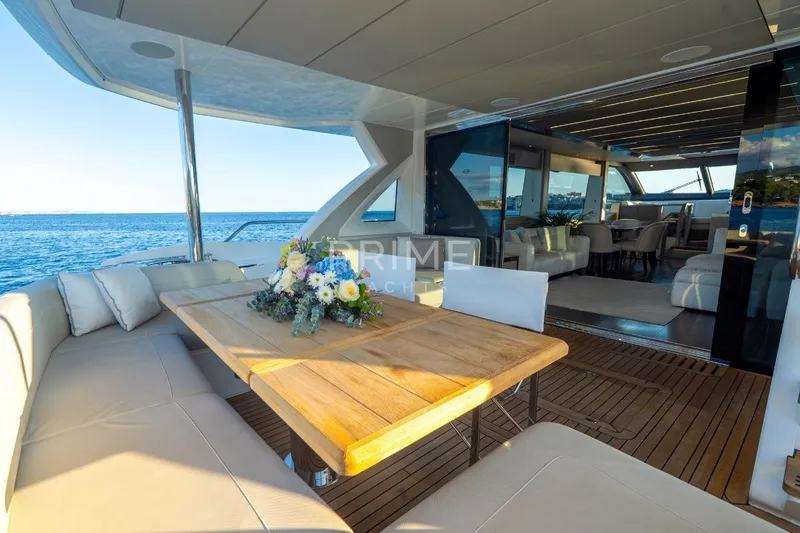 Lady M Yacht Photos Pics Luxurious 2019 Sunseeker 76 Yacht with elegant outdoor dining area and ocean view.
