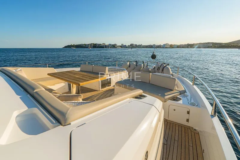Lady M Yacht Photos Pics Luxurious 2019 Sunseeker 76 Yacht with elegant deck seating, cruising on serene waters.