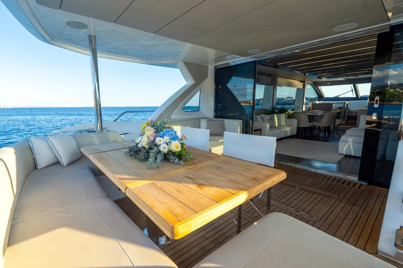 Lady M Yacht Photos Pics Luxurious 2019 Sunseeker 76 Yacht with elegant outdoor dining area and ocean view.