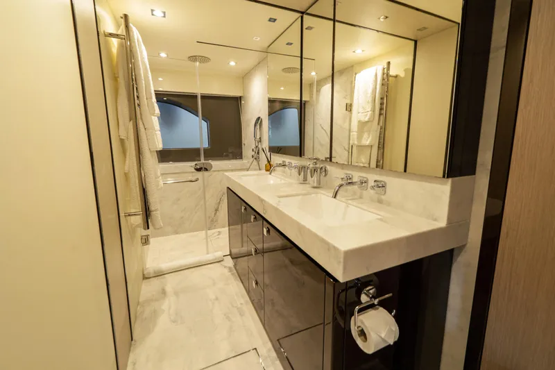 Lady M Yacht Photos Pics Luxurious bathroom in 2019 Sunseeker 76 Yacht with marble finishes and modern fixtures.