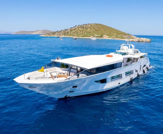  Yacht Photos Pics Luxurious Custom 42 yacht cruising in clear blue waters near a scenic island, built in 1983.