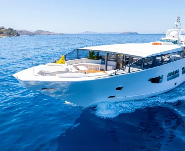  Yacht Photos Pics Luxurious custom yacht cruising on clear blue waters, featuring modern design and spacious deck.