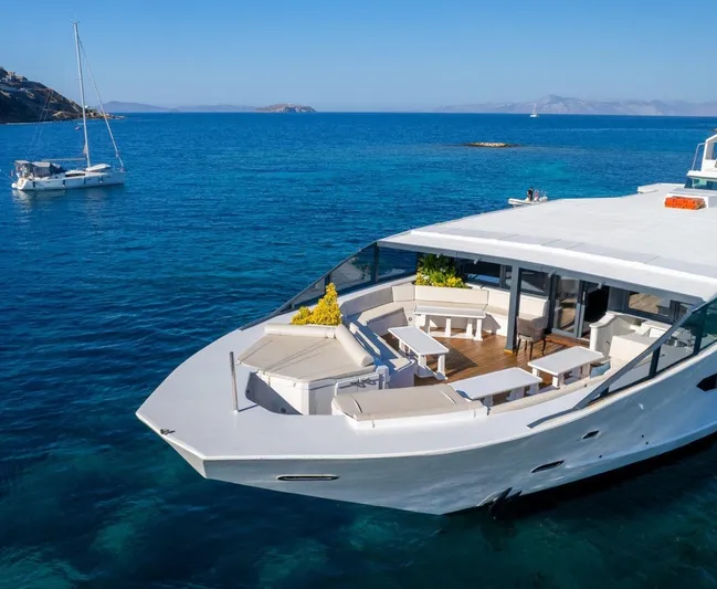  Yacht Photos Pics Luxurious Custom 42 yacht from 1983 on clear blue sea, featuring spacious deck seating.