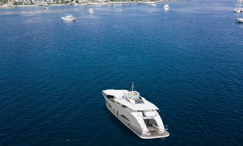  Yacht Photos Pics Luxurious custom yacht on serene blue waters, surrounded by smaller boats, 1983 model.