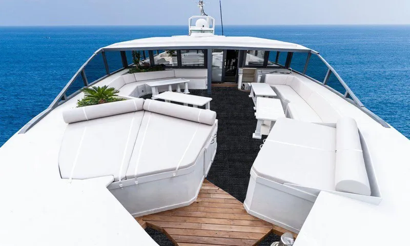  Yacht Photos Pics Luxurious yacht deck with white seating, Custom model 42, 1983, overlooking the ocean.