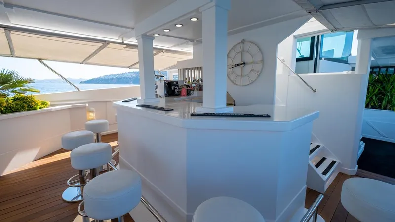  Yacht Photos Pics Luxurious yacht bar with white stools, modern design, and ocean view, Custom model 42, 1983.