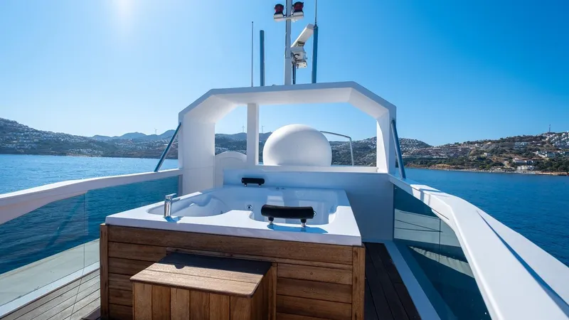  Yacht Photos Pics Luxurious yacht deck with hot tub, Custom model 42, 1983, scenic ocean view.