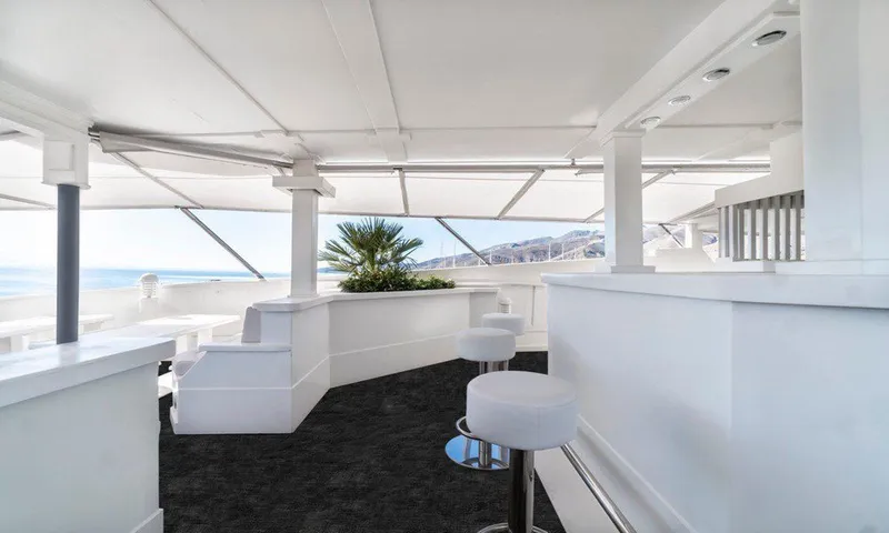  Yacht Photos Pics Luxurious yacht interior with white seating, ocean view, and modern design elements.