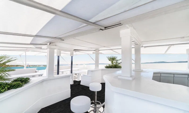  Yacht Photos Pics Modern white yacht deck with bar stools and ocean view, Custom model 42, 1983.