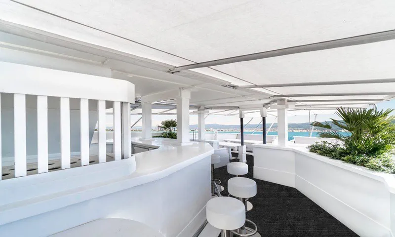  Yacht Photos Pics Luxurious yacht deck with modern bar stools and ocean view, Custom model 42, 1983.