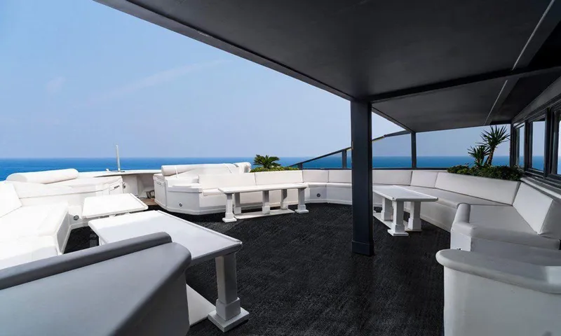  Yacht Photos Pics Luxurious yacht deck with white seating, ocean view, and modern design, Custom model 42, 1983.