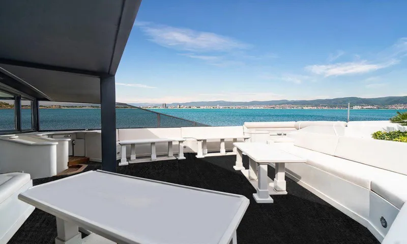  Yacht Photos Pics Luxurious yacht deck with white seating, ocean view, Custom 42 model, 1983.