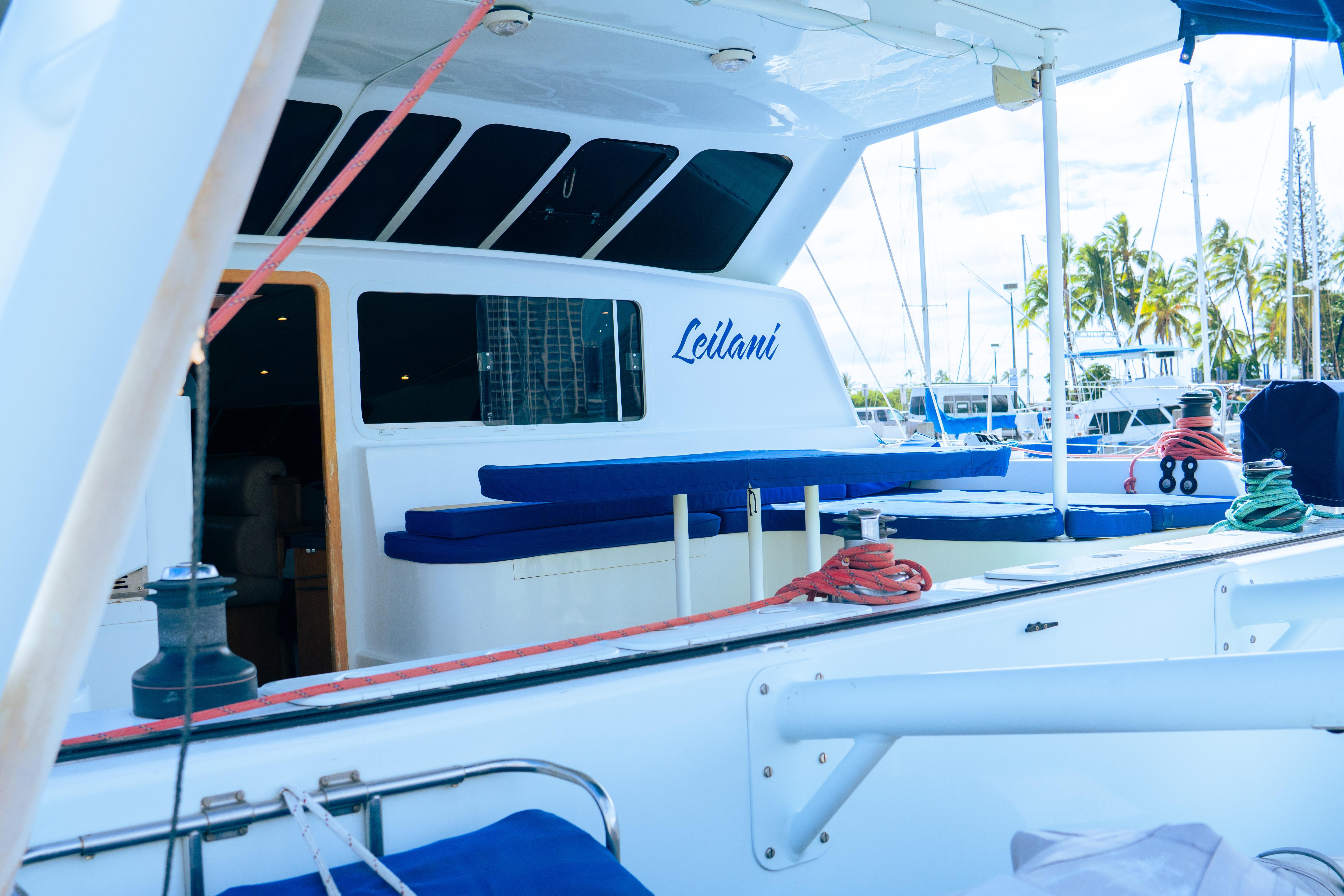 Luxury yacht deck with seating, ropes, and marina view; Custom model, 2005.