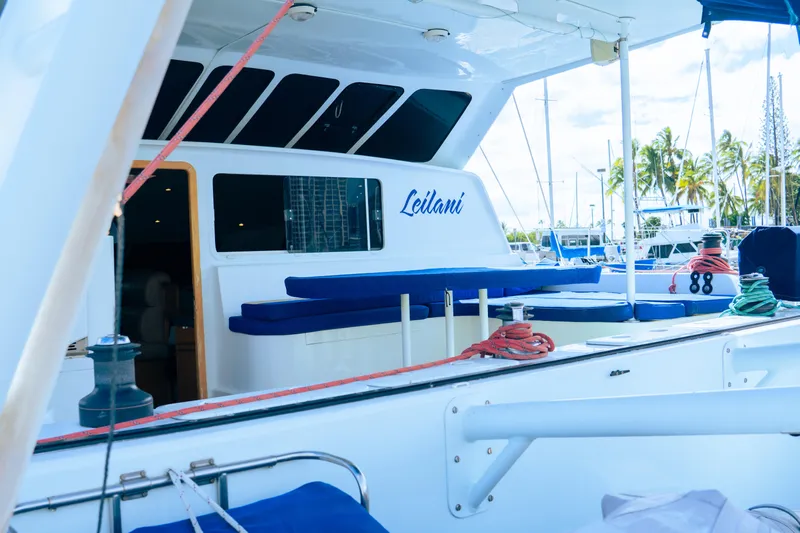 Leilani Yacht Photos Pics Luxury yacht deck with seating, ropes, and marina view; Custom model, 2005.